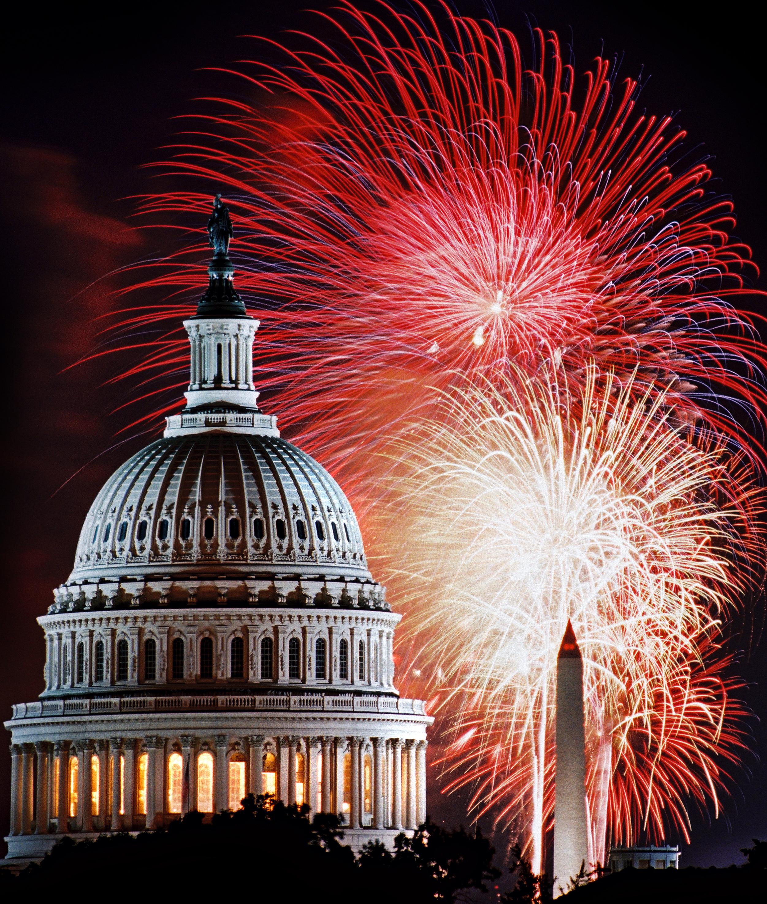 picture of the capitol building with fireworks behind it
